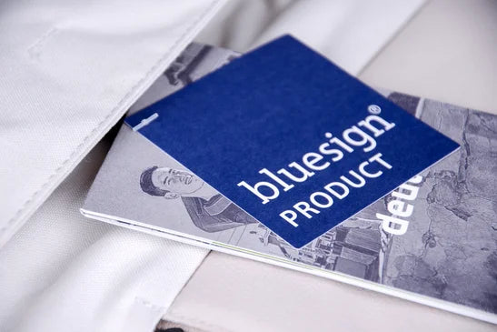 Tag that says "Bluesign Product" that is connected to a piece of white fabric.