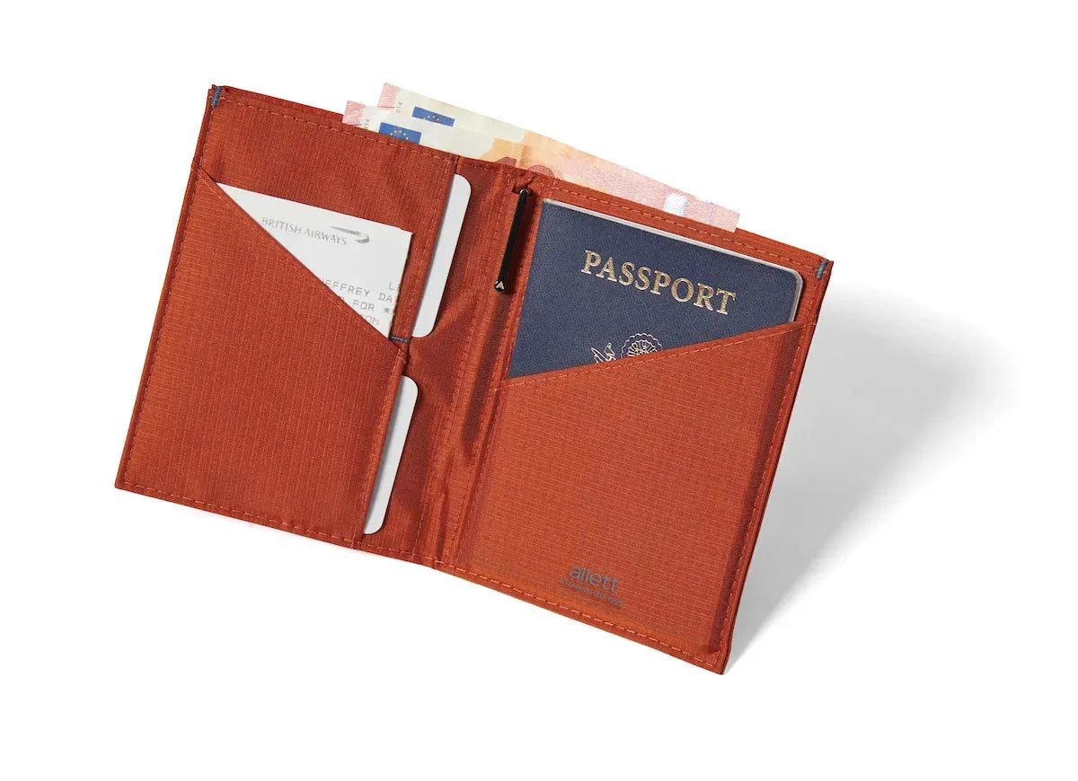 nylon travel wallet, unfolded to reveal a passport in the right compartment, cards on the left conveniently lodged in the central fold pocket. Allett Travel Wallet RFID Nylon - potters-clay