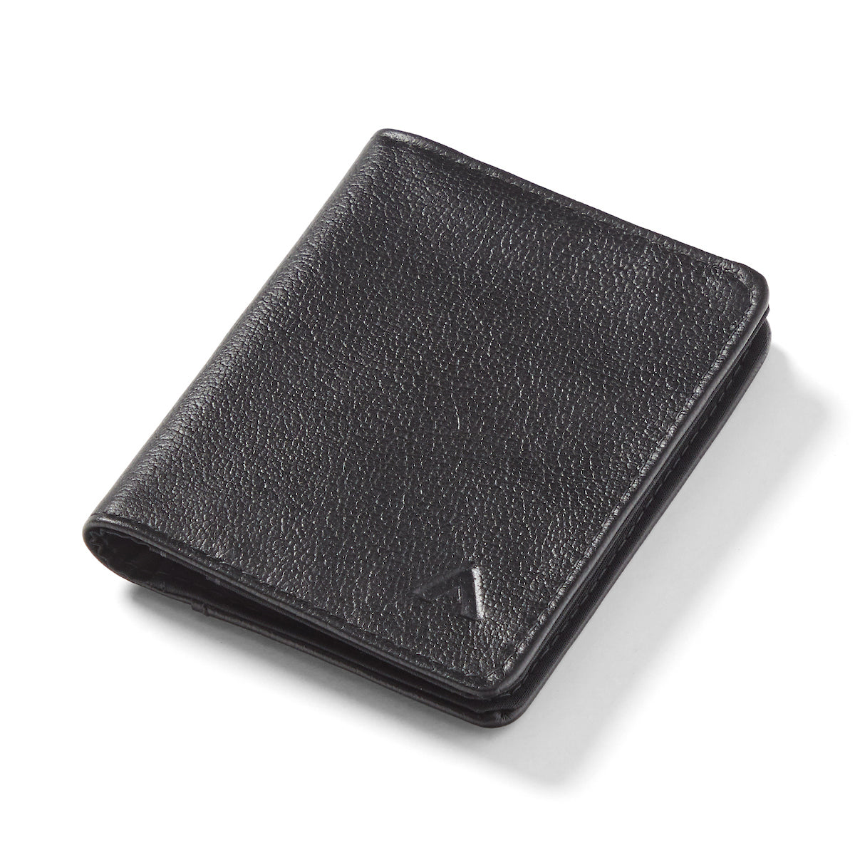 Onyx black leather hybrid card wallet against a white background, sitting closed. Leather hybrid card wallet onyx-black