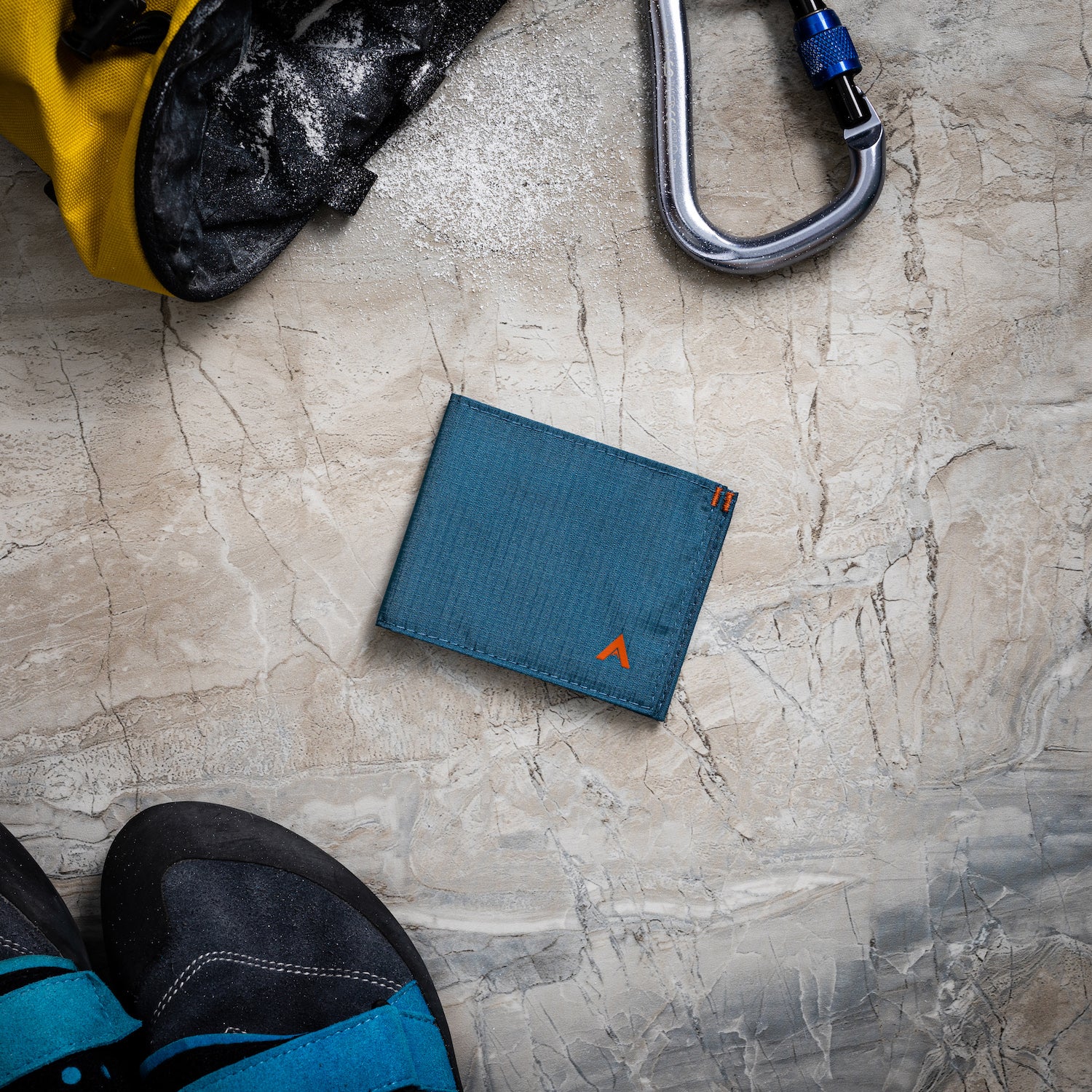 Indigo blue RFID sports wallet by Allett, accompanied by a micropen and other outdoor items on a table. Allett Sport Wallet RFID Nylon Front Pocket Wallet indigo-blue