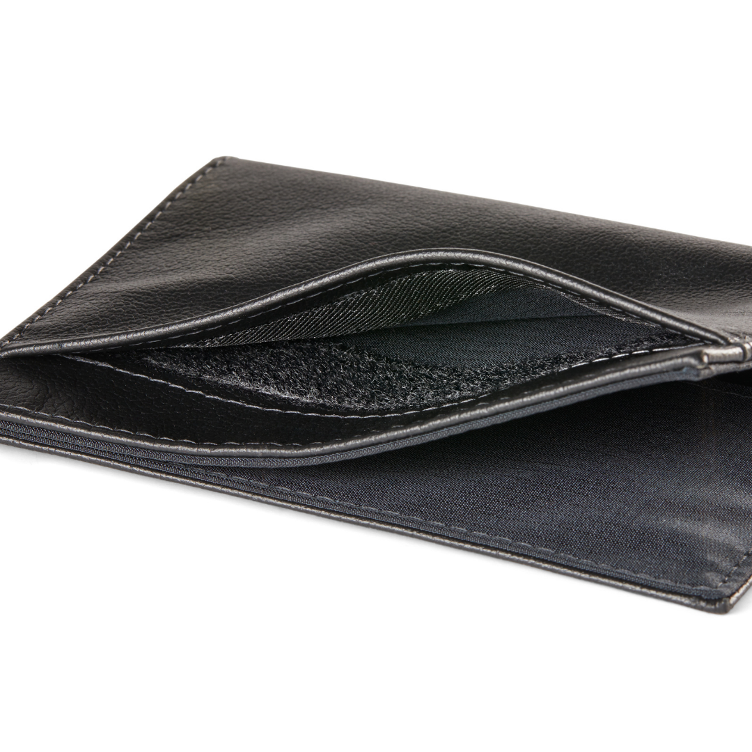 Magnified image of the velcro that secures coins on the outside of the slim onyx black leather coin wallet. allett leather coin wallet onyx-black