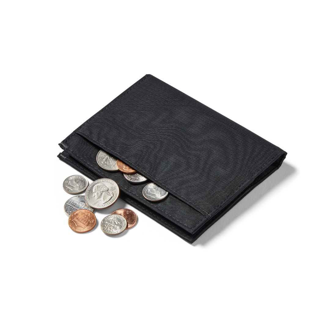 Coins spelling out of the exterior pocket of the jet black Allett nylon coin wallet. allett coin wallet jet-black